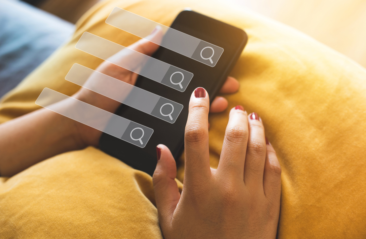 Searching and big data concepts with female hand using smart phone with search engine icon sign.Business information.global network system